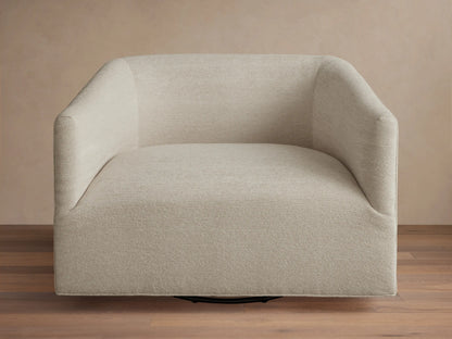 Oversized Ellison Swivel Chair, upholstered in light beige textured fabric, with curved arms & a visible black swivel base.