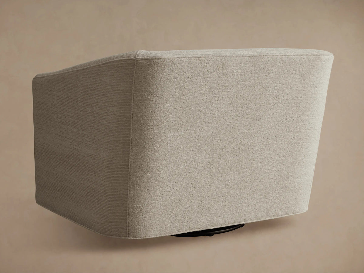 Ellison Oversized Swivel Chair, light beige textured woven fabric. High-angle close-up of curved armrest and seat.