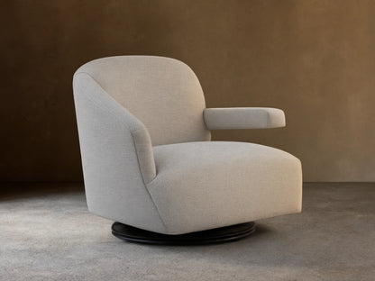 Oversized Ellison Swivel Chair, upholstered in light beige textured fabric, with curved arms & a visible black swivel base.