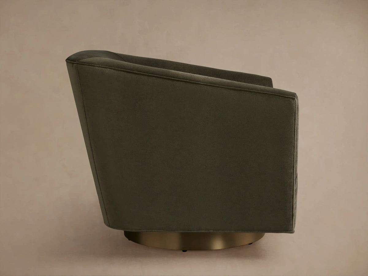 Dark grey Ellison Metal Plinth Swivel Chair close-up. Features soft fabric with a curved backrest and plush seat cushion, viewed from above.