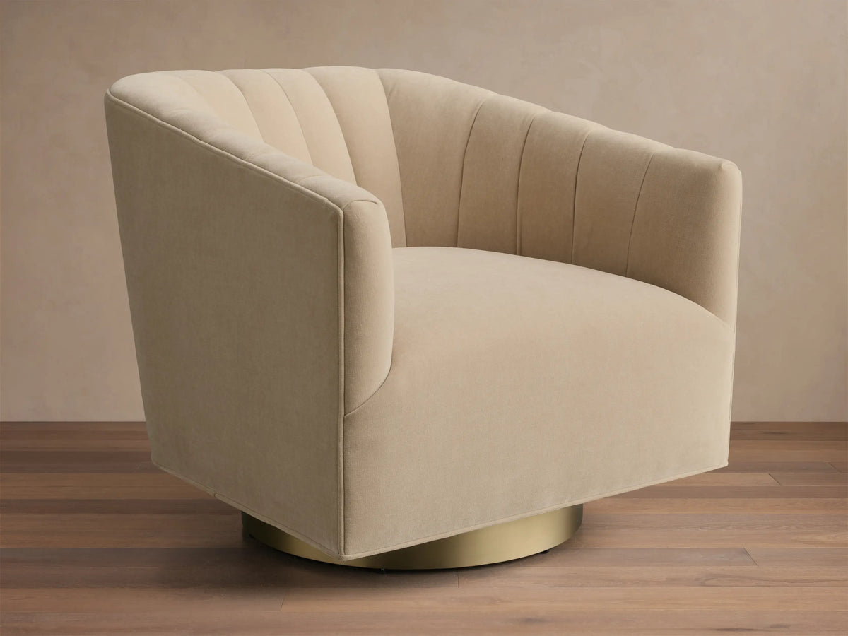 Front view of the beige Ellison Channel-Stitched Metal Plinth Swivel Chair with a channel-stitched backrest and gold metal plinth base.