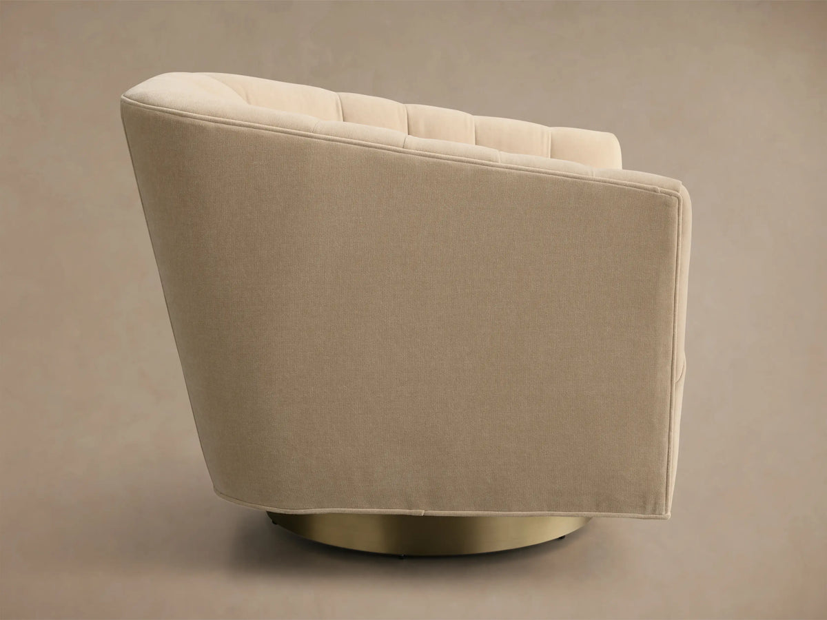 Side profile of a Cream Ellison Channel-Stitched Metal Plinth Swivel Chair™ with a channel-stitched backrest and gold metal plinth base.