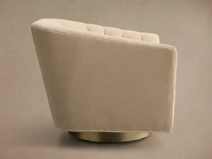 Side profile of a Cream Ellison Channel-Stitched Metal Plinth Swivel Chair™ with a channel-stitched backrest and gold metal plinth base.