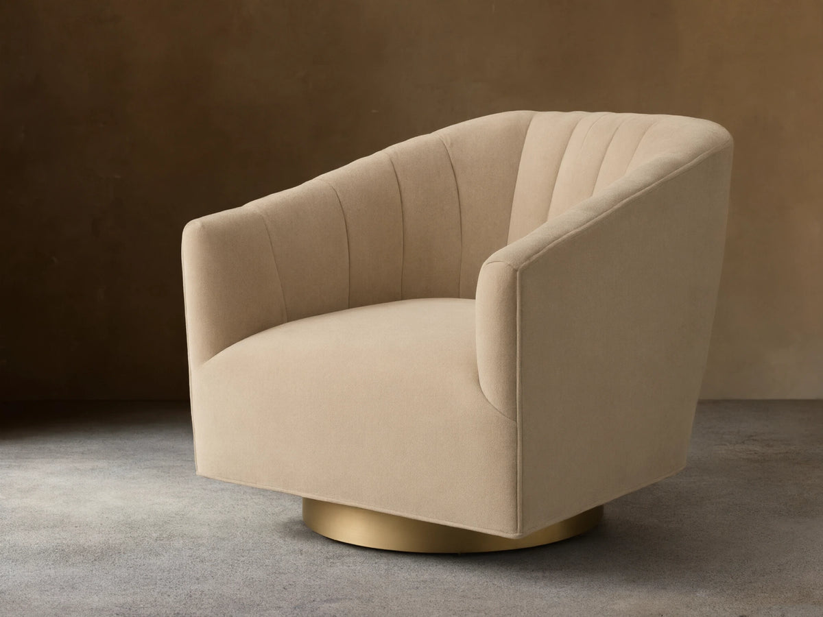 Front view of the beige Ellison Channel-Stitched Metal Plinth Swivel Chair with a channel-stitched backrest and gold metal plinth base.