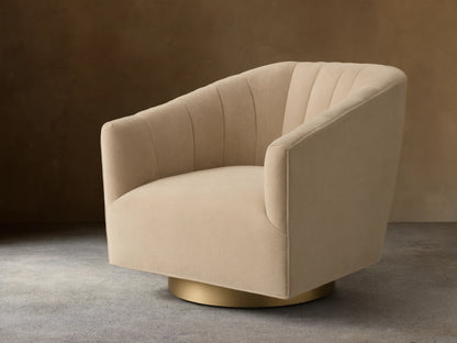 Front view of the beige Ellison Channel-Stitched Metal Plinth Swivel Chair with a channel-stitched backrest and gold metal plinth base.