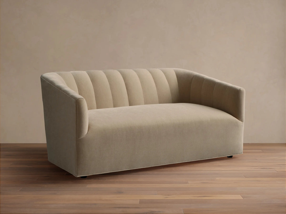 Ellison Channel-Stitched Sofa, light beige fabric, with a channel-stitched backrest and rounded arms, on a wood floor.