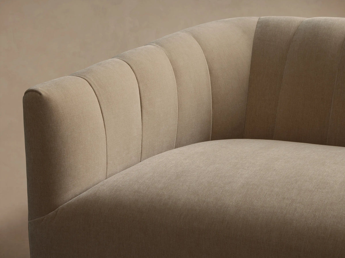 Ellison Channel-Stitched Sofa, light beige, angled. Features channel-stitched back, curved arms, on a wooden floor.