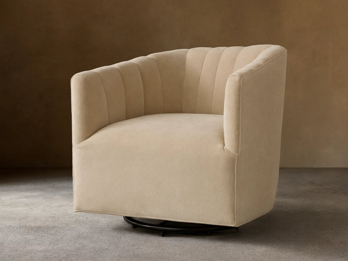 Front view of a Cream Ellison Channel-Stitched Swivel Glider with a curved back and vertical channel stitching.