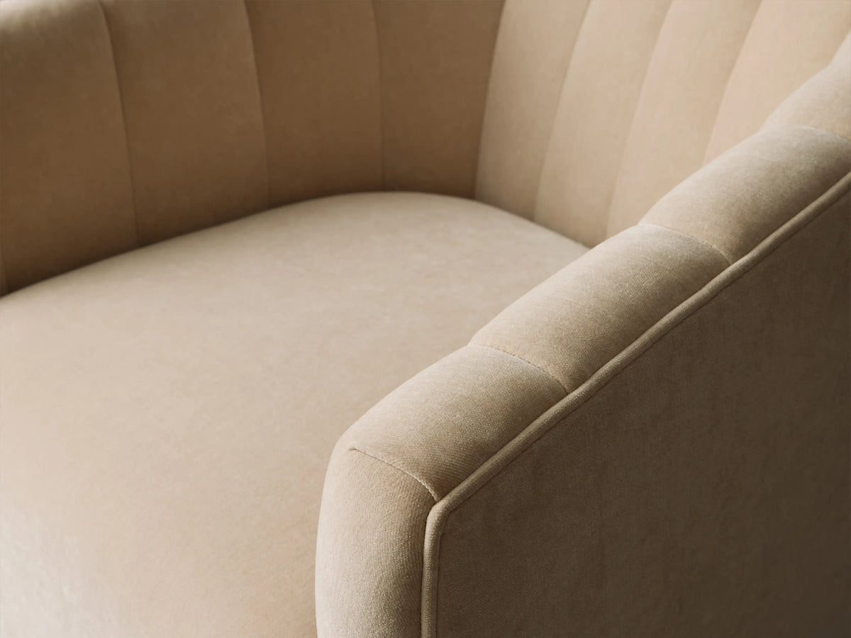 Side profile of the Cream Ellison Channel-Stitched Swivel Glider, showing the channel-stitched back and black swivel base.