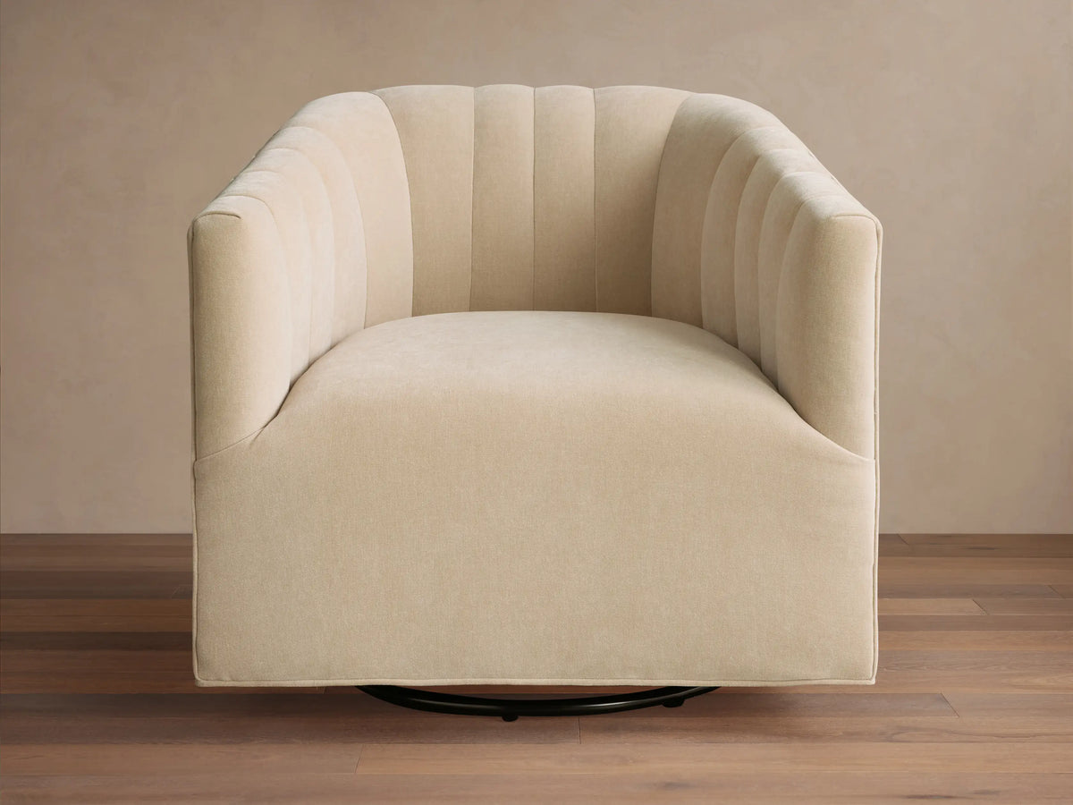 Close-up of the beige Ellison Channel-Stitched Swivel Glider, featuring visible channel stitching on the back and armrest.