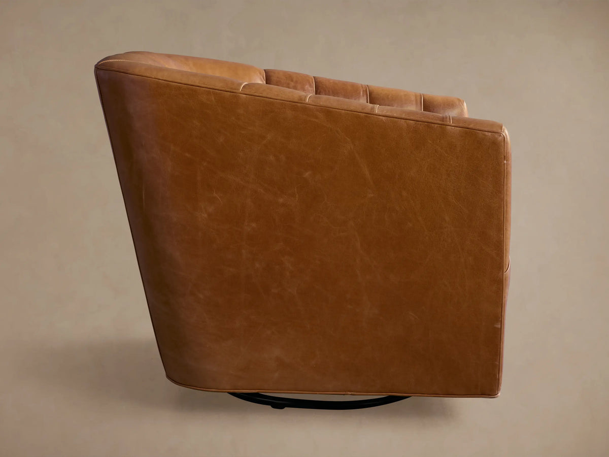 Ellison Leather Channel-Stitched Swivel Chair, angled back view. Rich tan leather with natural texture, black swivel base.