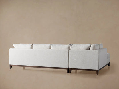 Bryden Daybed Sectional's lower section: light gray textured fabric, dark wood base, and tapered leg.