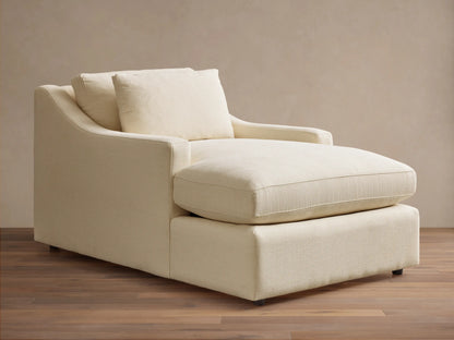 Front view of a cream Ashby Chaise with a long seat cushion, a plush back cushion, and one loose square pillow.