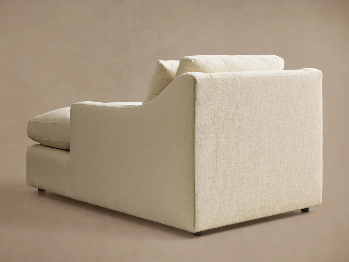 Front view of a cream Ashby Chaise with a long seat cushion, a plush back cushion, and one loose square pillow.