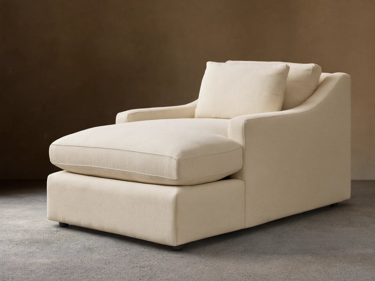 Front view of a cream Ashby Chaise with a long seat cushion, a plush back cushion, and one loose square pillow.