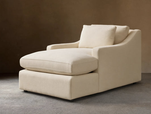 Front view of a cream Ashby Chaise with a long seat cushion, a plush back cushion, and one loose square pillow.