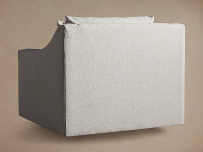 Close-up of Ashby Swivel Chair, showing the curved armrest, seat, and back cushion in light beige textured fabric.
