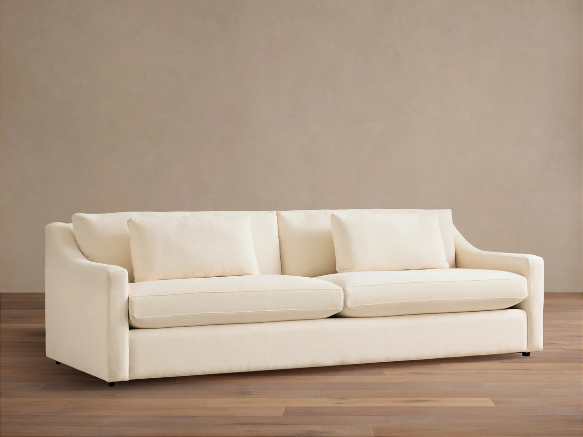 Front view of a cream Ashby Sofa with two large seat cushions, two back cushions, and two rectangular throw pillows.