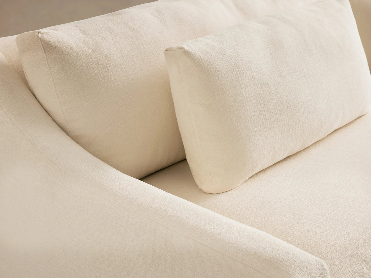 Front view of Cream Ashby Sofa with clean lines, wide slightly sloped arms, two plush seat cushions, and three back cushions.