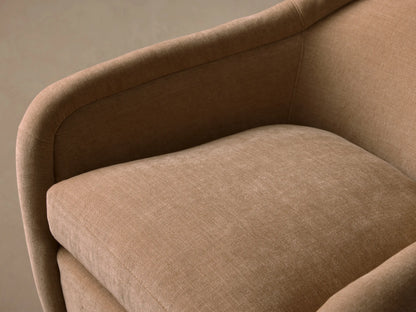 Ashbury Swivel Chair: light beige upholstered chair with rounded back, arms, plump cushion, and dark circular swivel base.