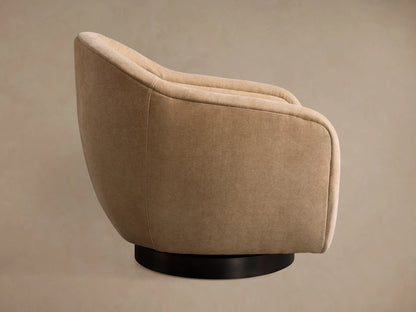 Light beige Ashbury Swivel Chair, angled back view, showcasing its rounded form and black circular base.