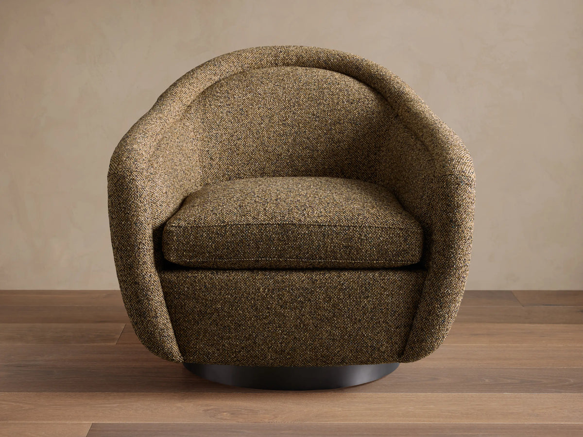 Two dark brown textured Ashbury Swivel Chairs with curved backs facing a light beige sofa in a cozy living room.