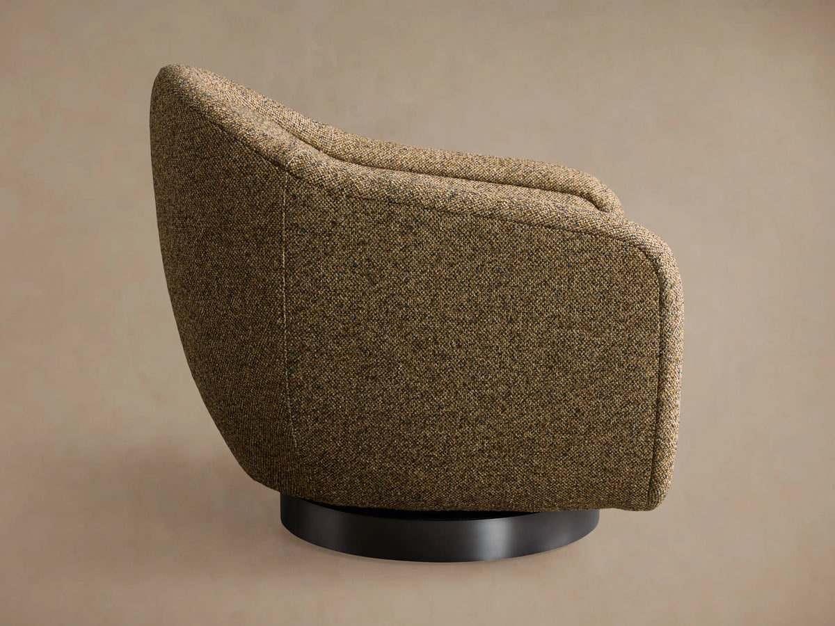 Ashbury Swivel Chair, rear view, upholstered in a multi-toned brown, gold, and olive textured fabric, on a black swivel base.