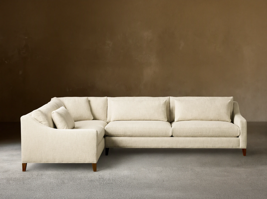 Front view of a cream Ashby Elevated Two-Piece Sectional, featuring a left-hand corner configuration and mocha wooden legs.
