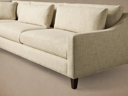 Front view of a light beige L-shaped Ashby Elevated Two-Piece Sectional with plush cushions and mocha finish feet.