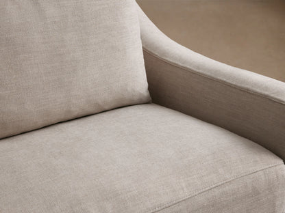 Ashby Slipcovered Swivel Chair in a light beige fabric, featuring a boxy design with padded seat and back cushions on a wooden floor.
