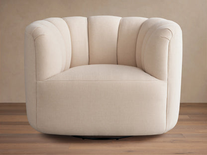 Beige Amira Swivel Chair with tufted backrest and plush seat, featuring 360-degree rotation on a wooden floor, viewed at an angle.