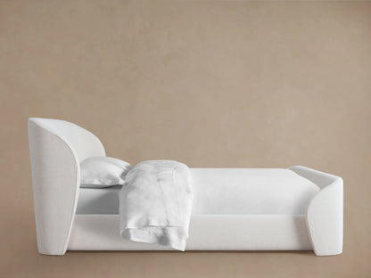 Adalynn Bed with High Footboard, featuring a plush white upholstered headboard and matching footboard, on wooden flooring.