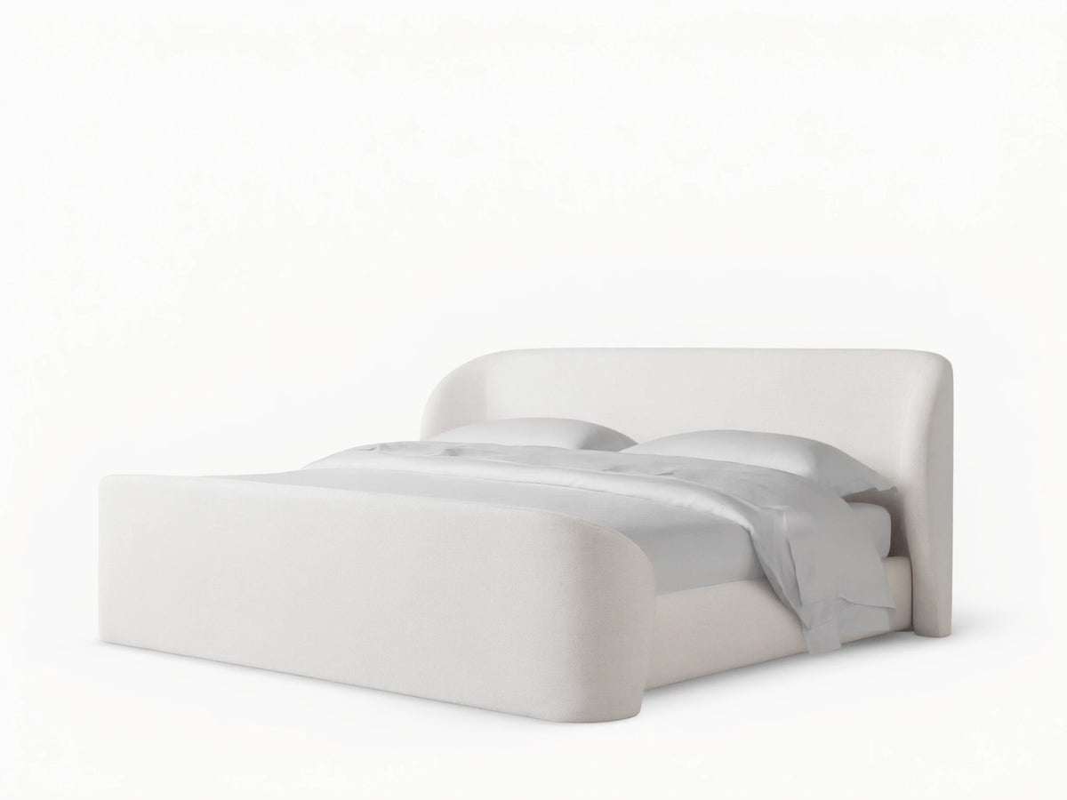 Adalynn Bed with High Footboard, featuring a plush white upholstered headboard and matching footboard, on wooden flooring.