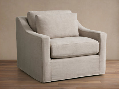 Back view of the Ashby Slipcovered Swivel Chair in light beige fabric, featuring a cushioned backrest and clean, smooth lines.
