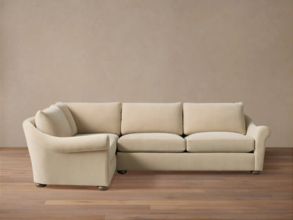 Beige Archwood Two-Piece Sectional on wooden floor, featuring plush cushions, L-shaped design, rolled arms, and dark wooden legs.