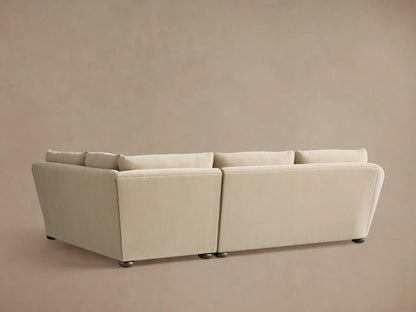 A close-up of the Archwood Two-Piece Sectional shows a soft beige fabric with plush cushions and gently curved armrests.