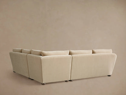 Alt text: Beige Archwood three-piece corner sectional with plush cushions and smooth upholstery, showing rounded armrest and soft fabric texture.
