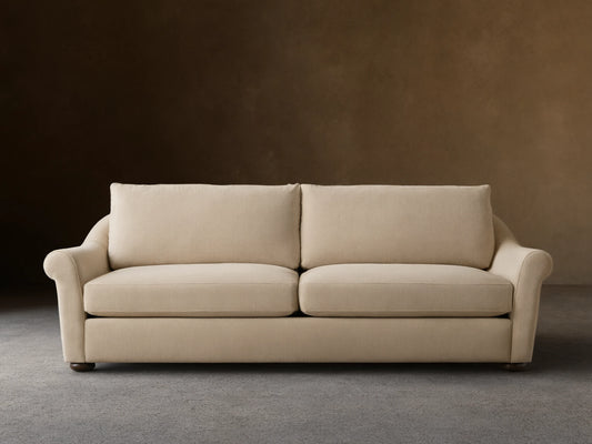 Front view of Cream Archwood Sofa with two seat and back cushions, rolled arms, and dark feet.