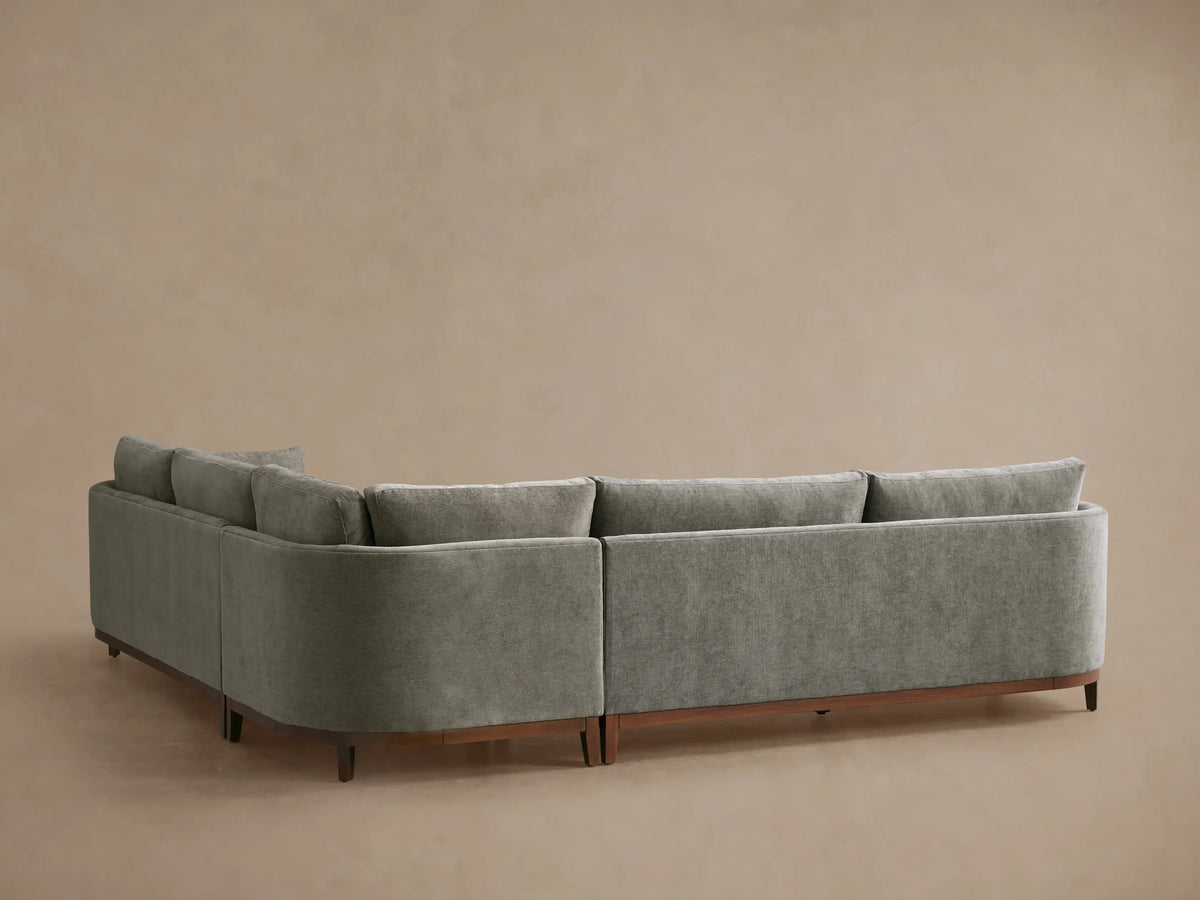 Close-up, elevated view of a Bainbridge Three-Piece Corner Sectional in soft, muted sage green fabric with plush cushions.