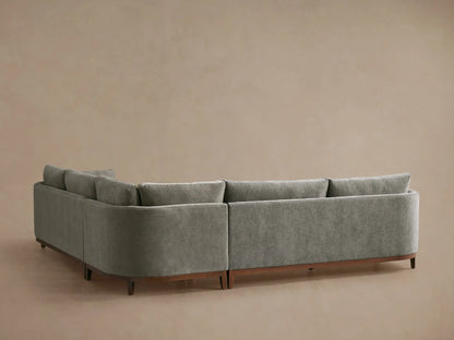Close-up, elevated view of a Bainbridge Three-Piece Corner Sectional in soft, muted sage green fabric with plush cushions.