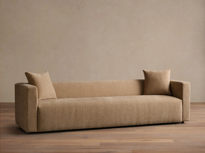Front view of the beige Brady Sofa with two matching throw pillows, featuring thick arms and a modern, minimalist design.