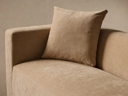 Front view of a beige Brady Sofa with two matching throw pillows on a wooden floor.