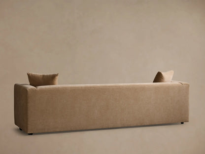 Close-up view of the tan Brady Sofa's textured fabric on the seat, armrest, and a square throw pillow.