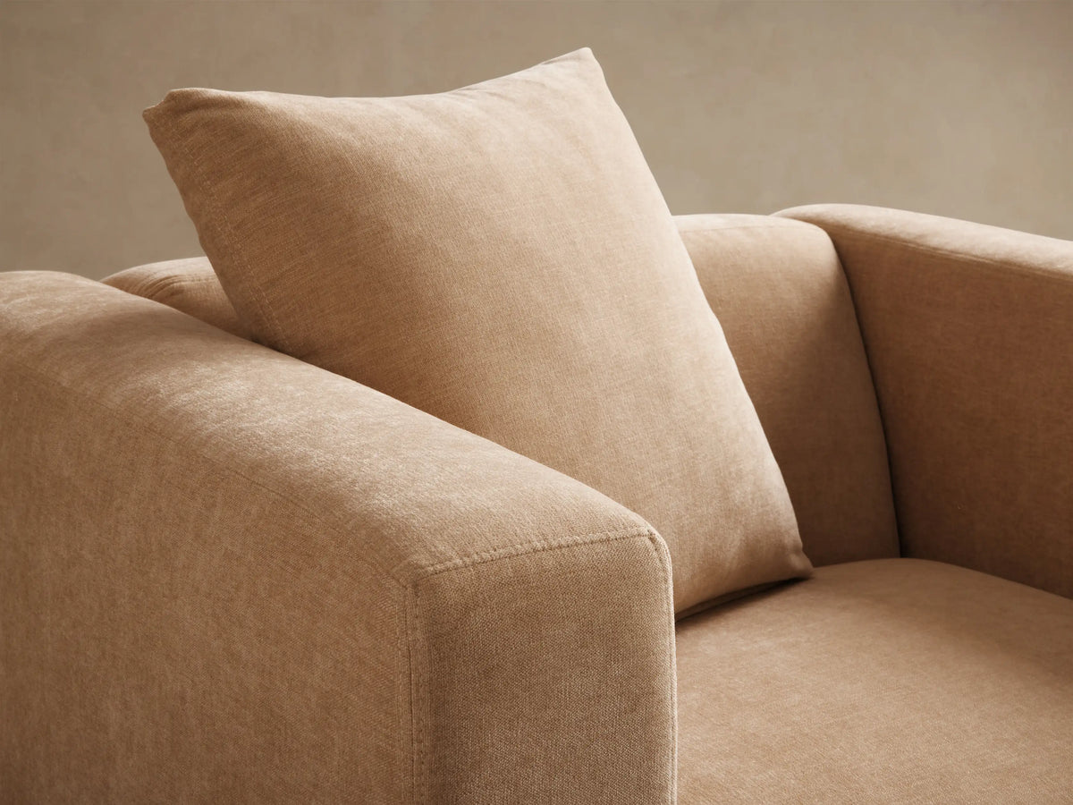 Close-up, angled view of the textured beige Brady Swivel Chair, highlighting the squared arm and back cushion.