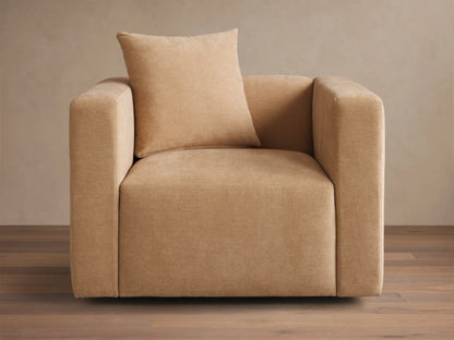 Front view of a beige Brady Swivel Chair, a cube-shaped armchair with a matching square pillow.