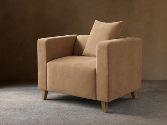Front view of the tan Brady Swivel Chair, featuring a square, modern design with thick arms and a matching back cushion.