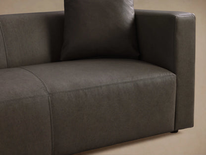 Front view of the dark gray Brady Leather Sofa, a long, modern couch with clean lines and two matching throw pillows.