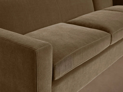 Bronte Three-Piece Corner Sectional in brown fabric, featuring plush cushions and a minimalist design on a hardwood floor.