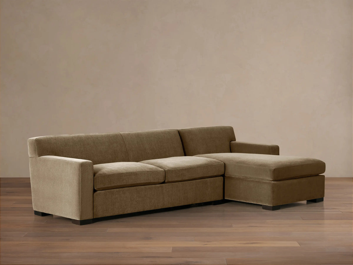 Bronte Two-Piece Chaise Sectional in muted olive green, with a right-facing chaise, on a wood floor against a light wall.