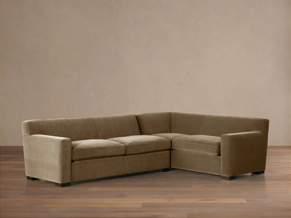 Bronte Two-Piece Sectional, L-shaped, upholstered in muted olive-brown fabric, with dark feet, on a wood floor.